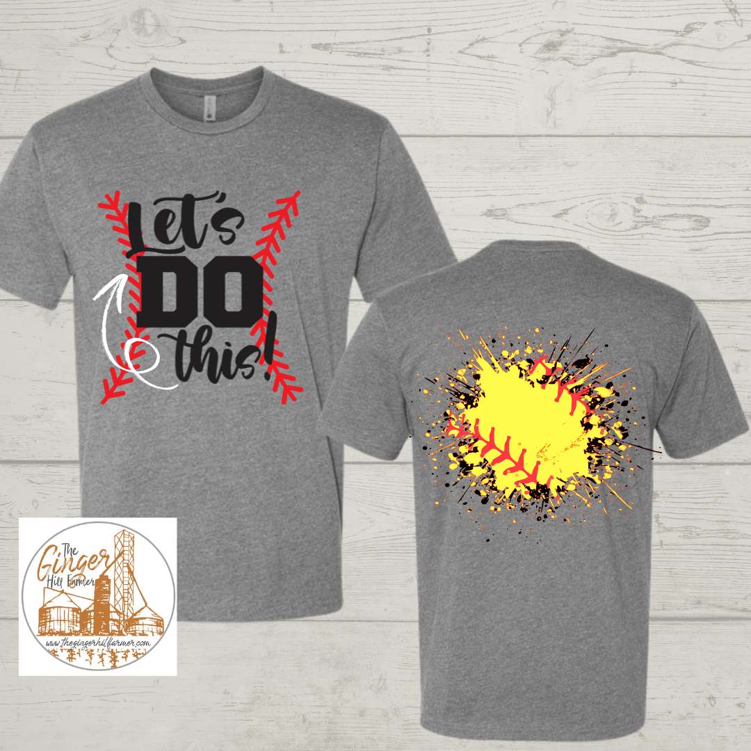 Gray t-shirt with 'Let's Do This!' design on front and colorful abstract design on back, on a wooden surface.