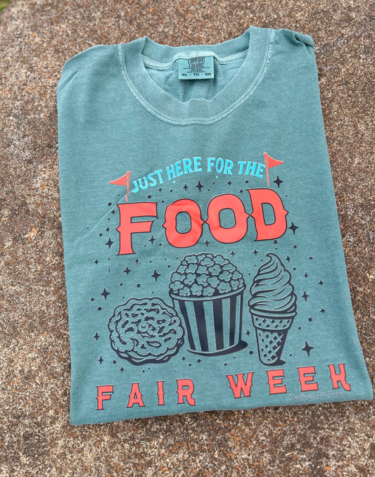 green shirt folded with graphic