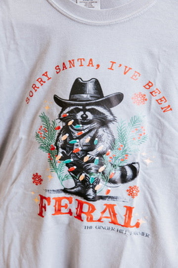 White t-shirt with a raccoon graphic and text on a white background