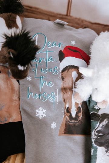 Gray sweatshirt with horse graphic and text 'Dear Santa, it was the horses!' worn by a person.