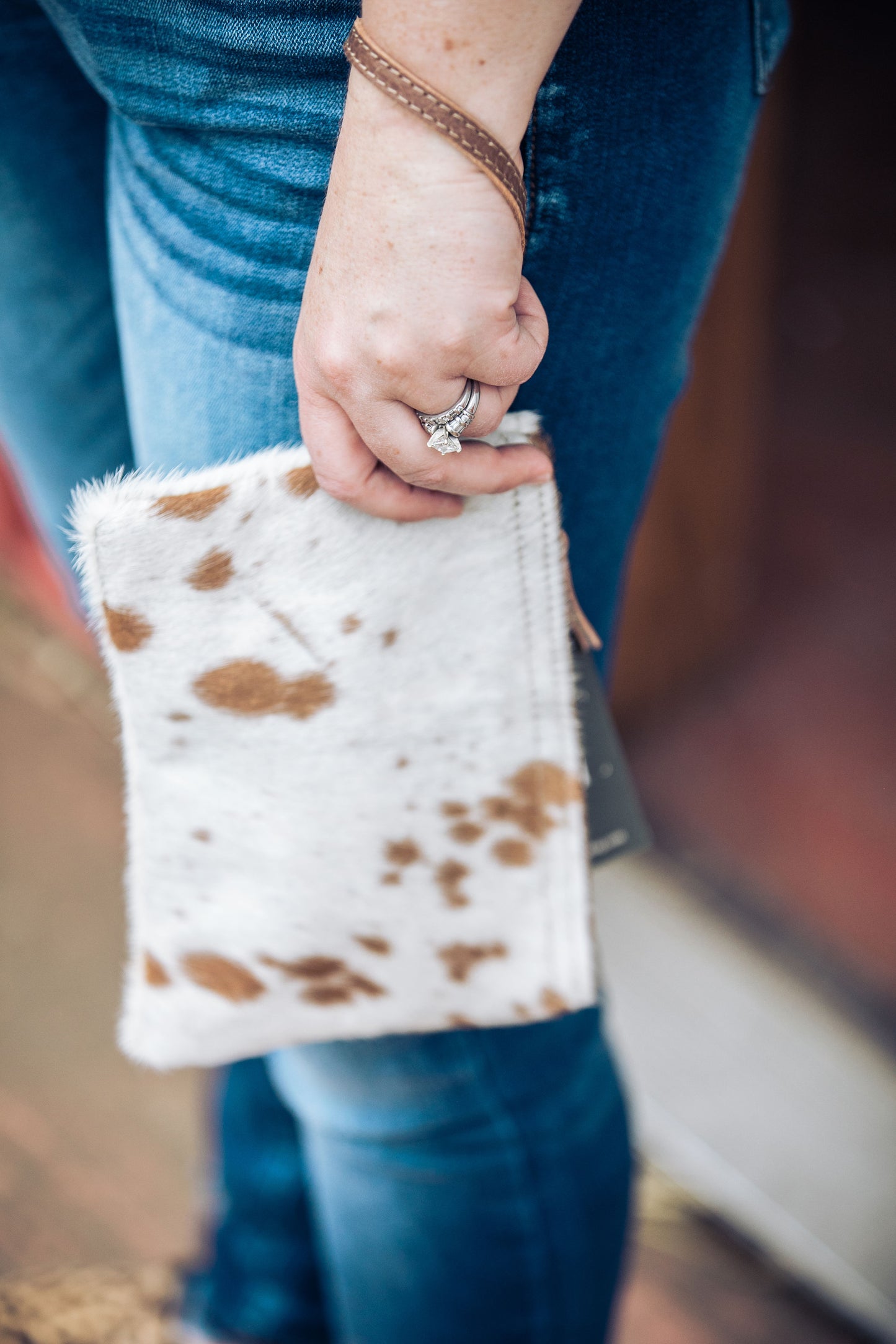 White & Brown Hair-on Wristlet being held by model