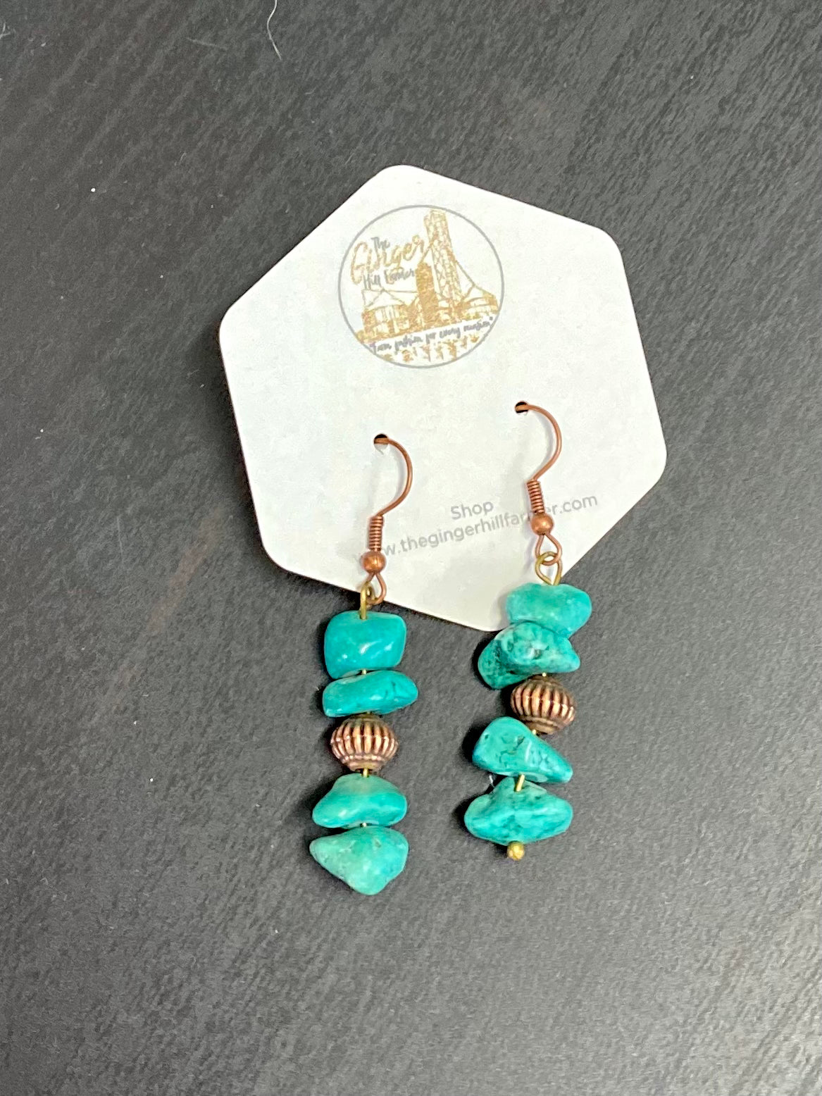 stone pendant earrings laying flat