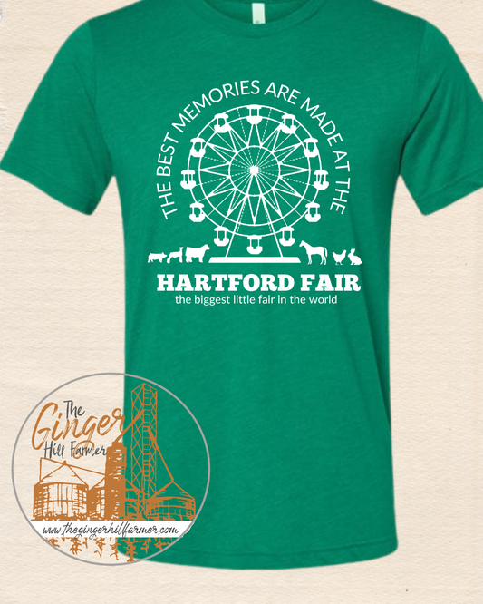 Green t-shirt with white graphic and text about Hartford Fair on a beige background