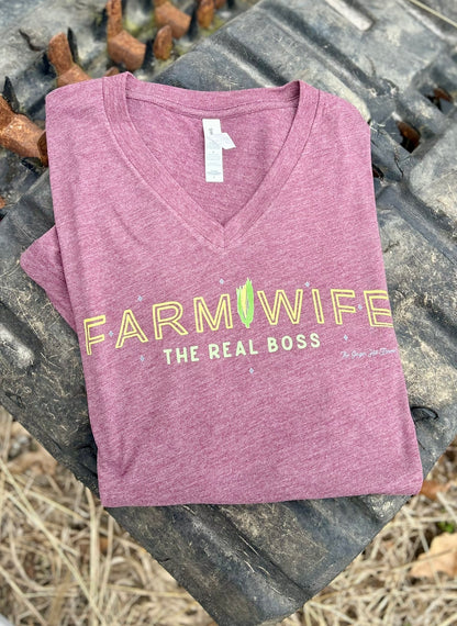 Purple t-shirt with 'Farmwife, The Real Boss' text on a rustic background
