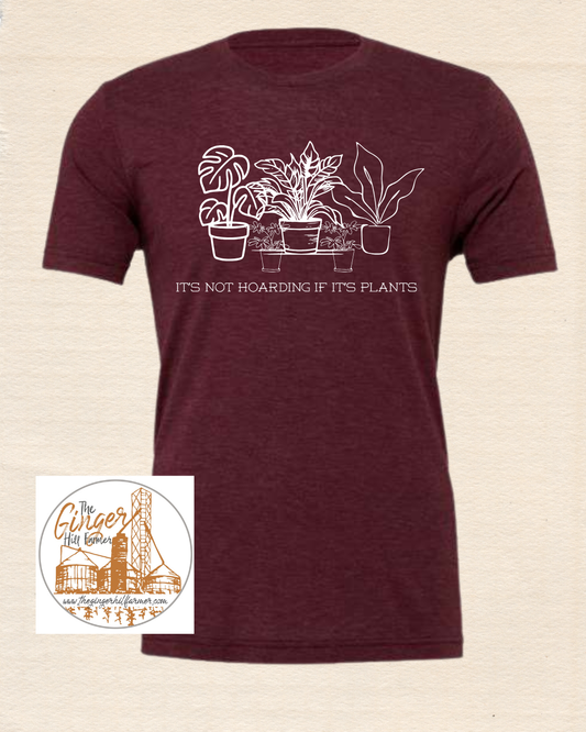 maroon tee with white graphic on a beige background