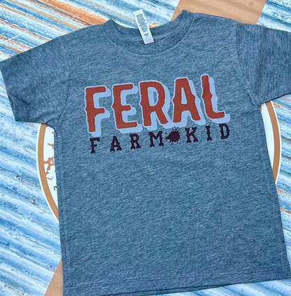 grey t-shirt with 'FERAL FARM KID' text on a striped background