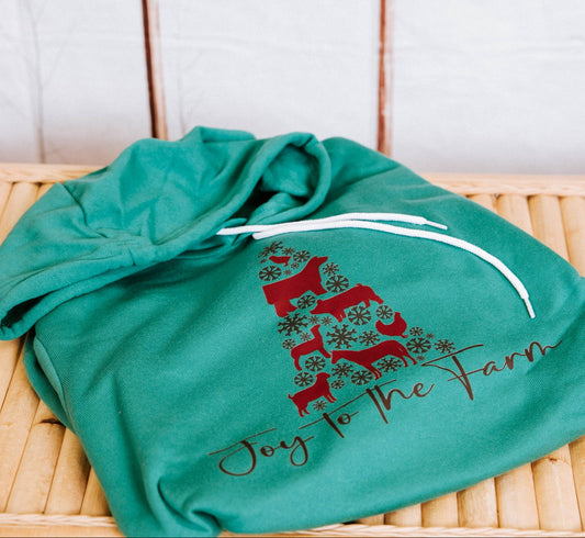 Green shirt with red and brown design on a wooden surface with a tiled wall background