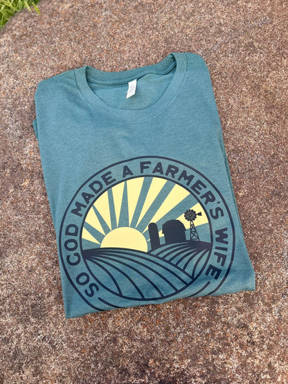 Folded blue t-shirt with a graphic design on a textured surface