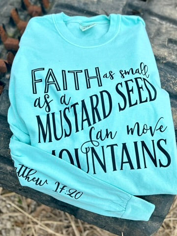 Light blue sweatshirt with motivational text on a stone surface