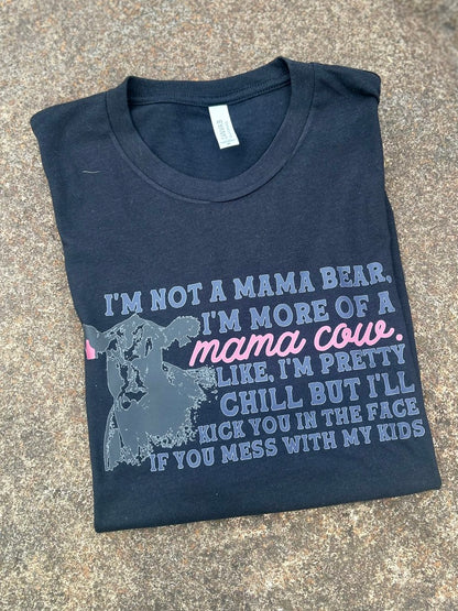 Folded black t-shirt with humorous text design on a concrete surface