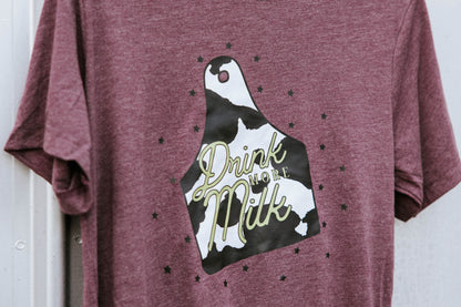 Close up of cattle tag graphic on a maroon tee