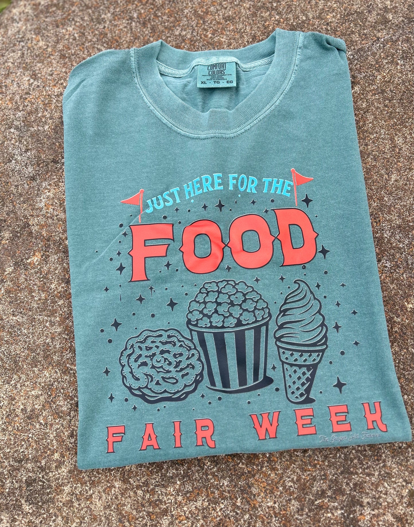 green shirt folded with graphic