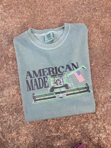 Folded t-shirt with 'American Made' graphic on a textured surface