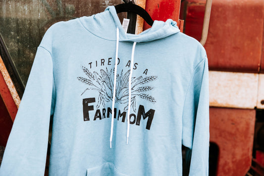 Close up of blue sweatshirt hanging on a red tractor