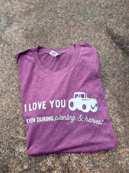 maroon t-shirt with white text and graphic on a textured surface