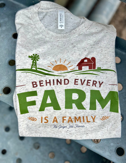 Gray t-shirt with farm-themed design and text on a metal surface