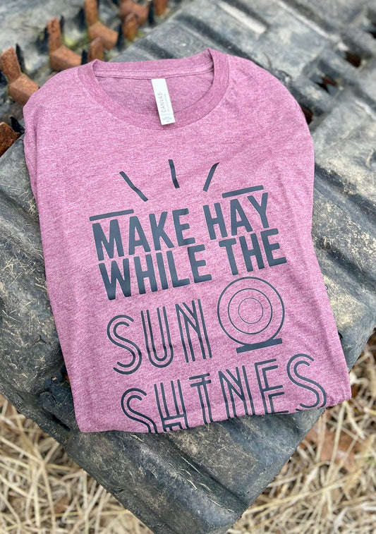 maroon tshirt with black graphic on a tractor tire