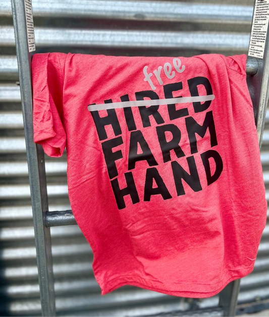 red tee hanging on a metal bin