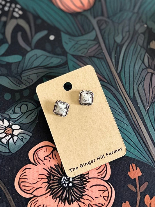 image of white stone earrings on cardboard backing
