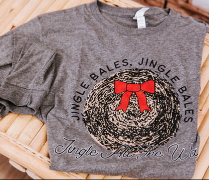 grey tee shirt laying flat with straw bale graphic
