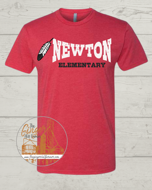Red t-shirt with 'Newton Elementary' text and feather design on a wooden surface