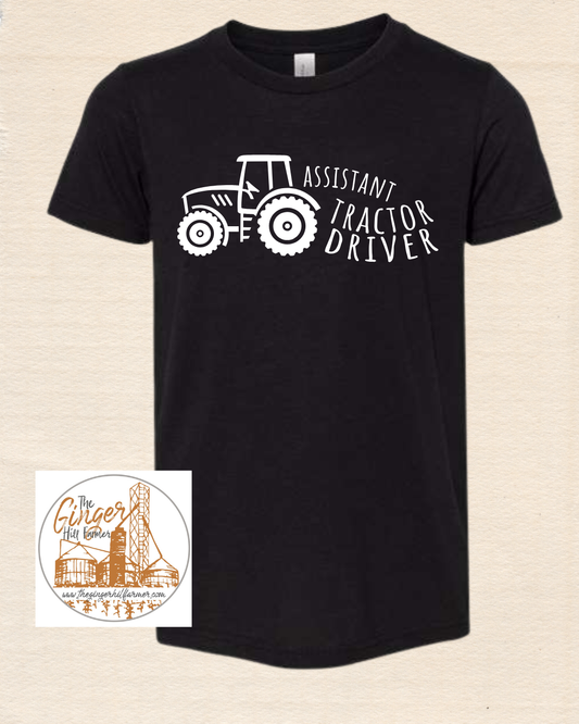 Black t-shirt with a white tractor graphic and text on a beige background
