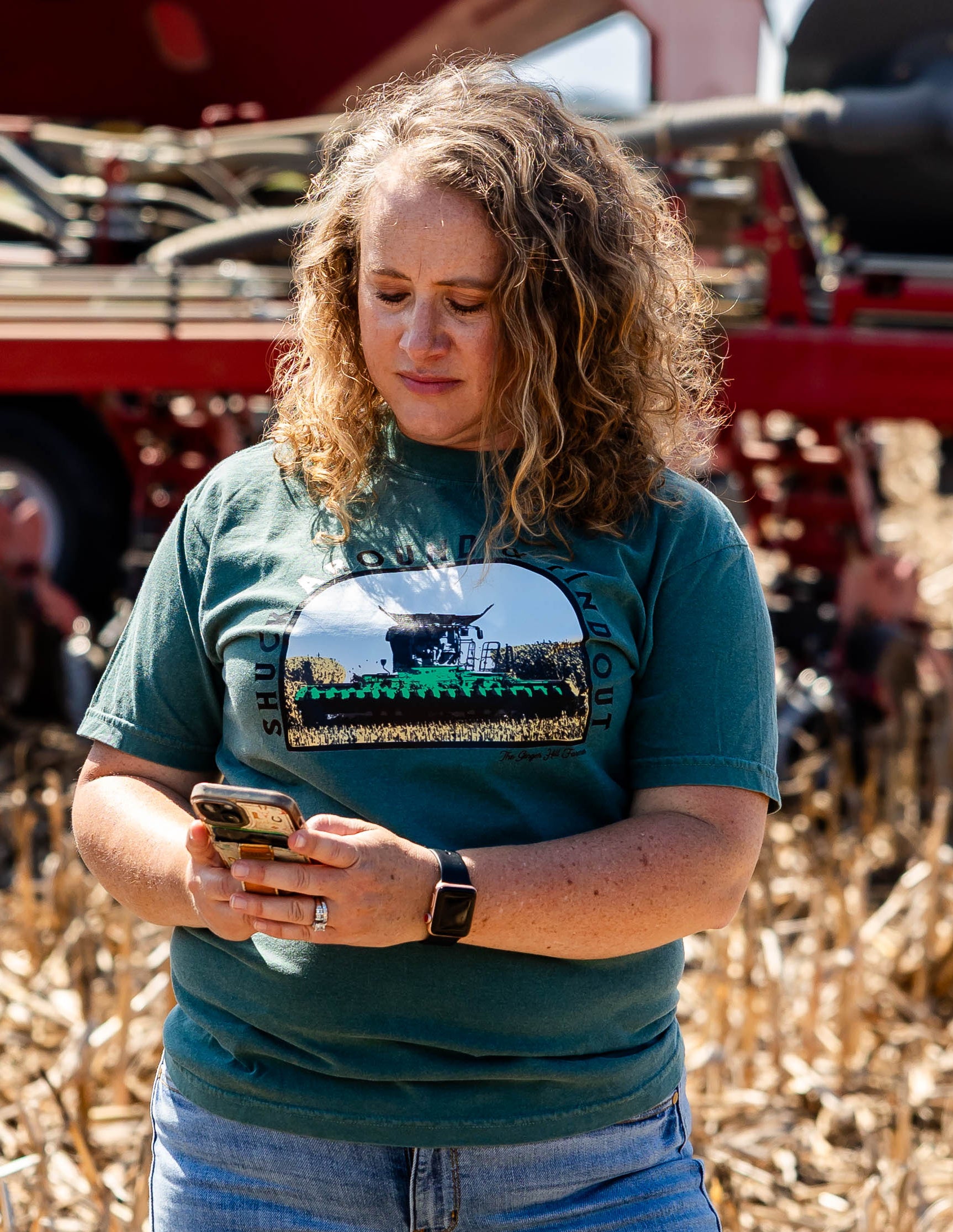 model wearing tee holding a phone