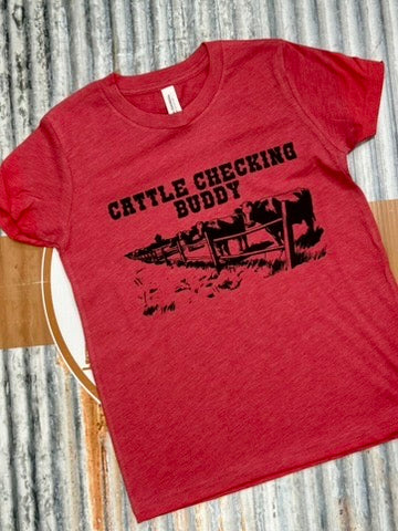 Red t-shirt with 'Cattle Checking Buddy' text and graphic on a corrugated metal background