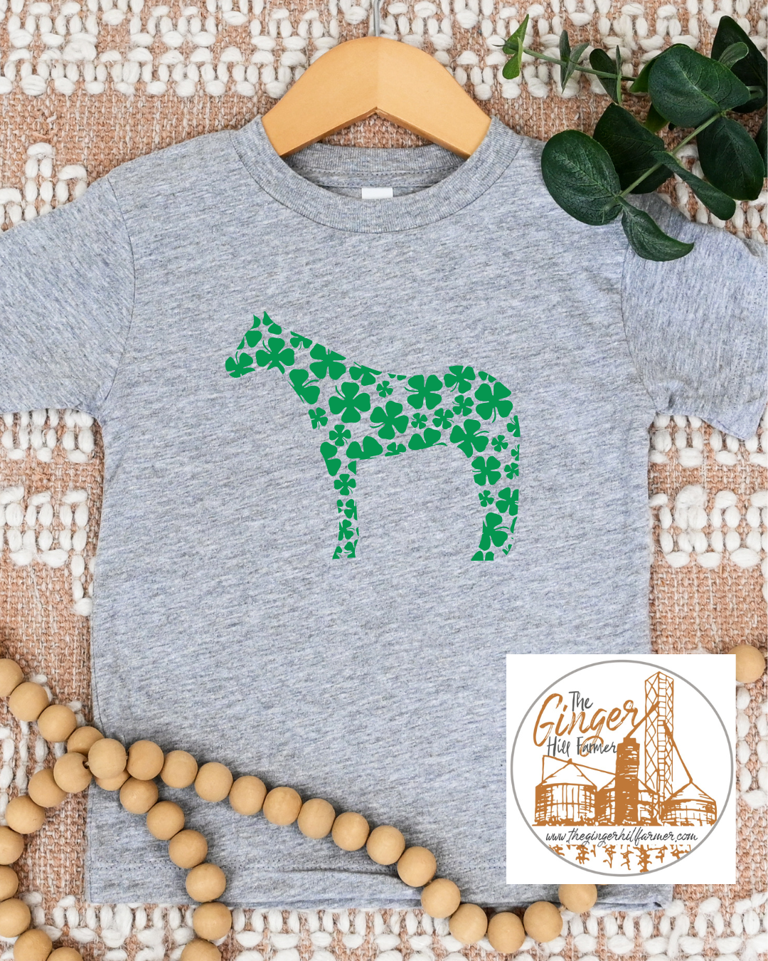 grey tee with a horse made of clovers on a textured background