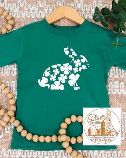 green tee with a rabbit made of clovers on a textured background