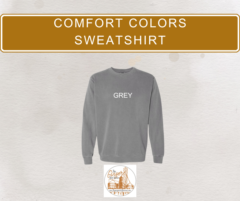 Gray sweatshirt with 'GREY' text on a textured beige background, featuring a brand logo at the bottom.