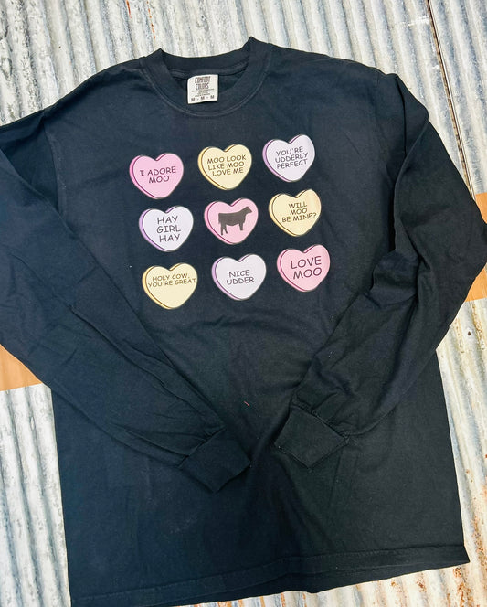 Black long-sleeve shirt with colorful heart-shaped buttons on a textured surface