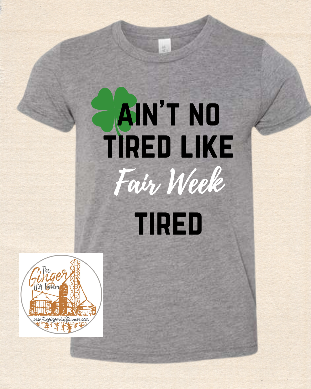 grey shirt with writing on tan background