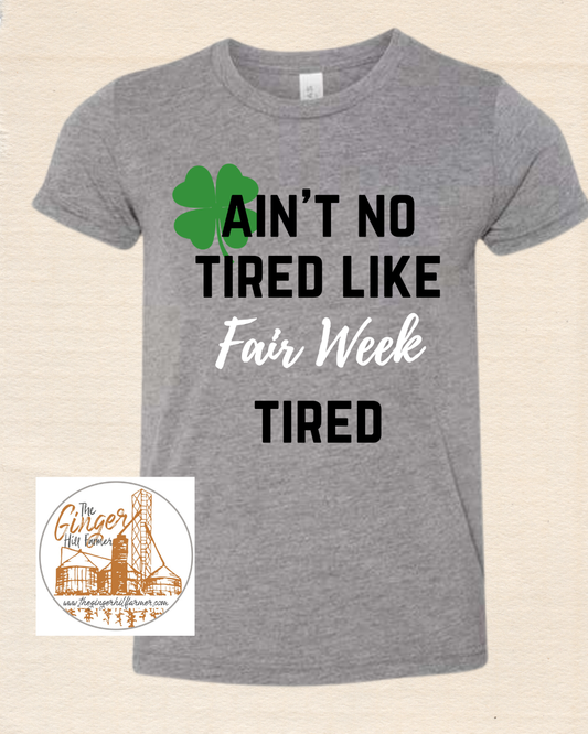 grey shirt with writing on tan background