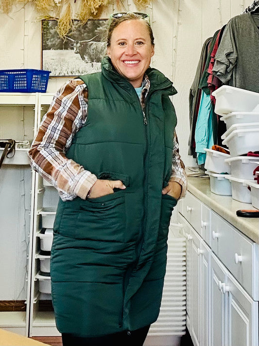 model wearing green puffer vest