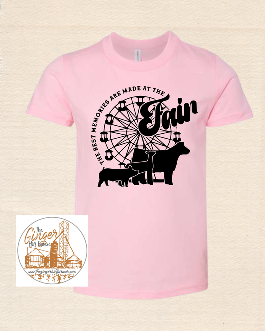 Pink t-shirt with black graphic design on a beige background