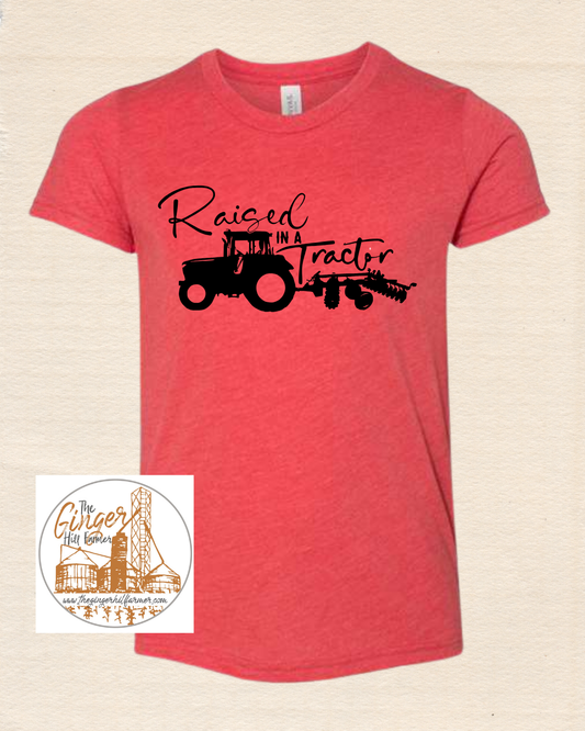 red shirt with black graphic on a tan background