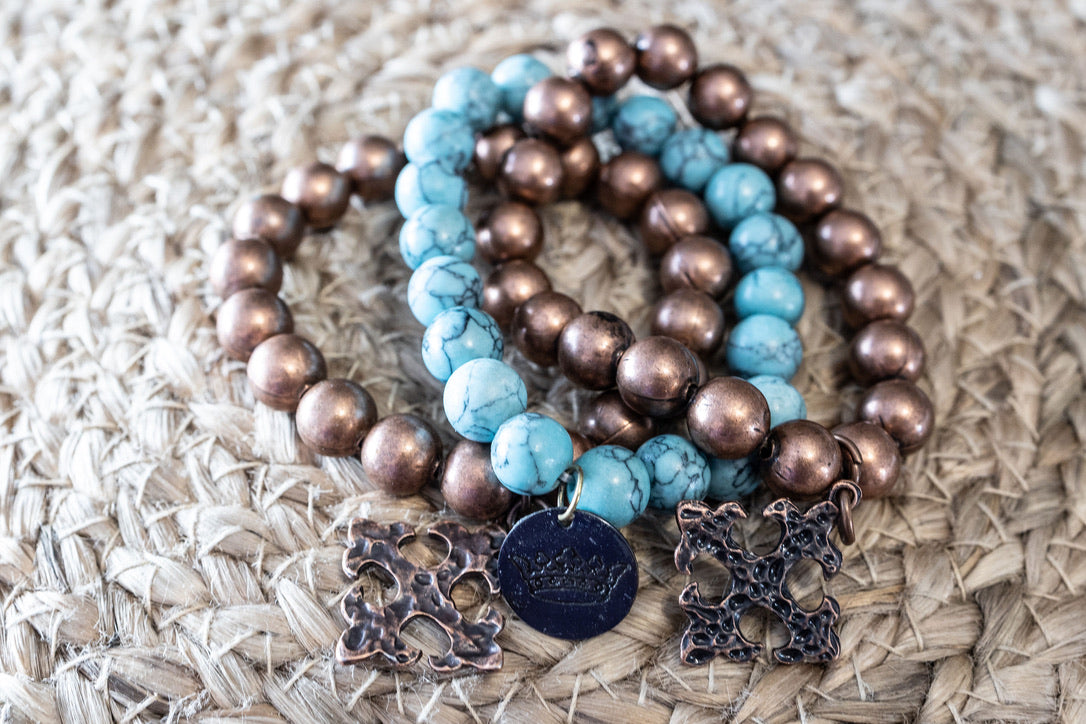 flat lay of turquoise bracelet mixed with copper bead bracelet